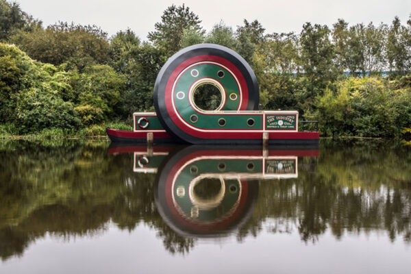 Canal boat on British canal way. The boat has a large loop in its design