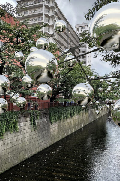 Reflective spheres attached to a kinetic installation over Amsterdam canal