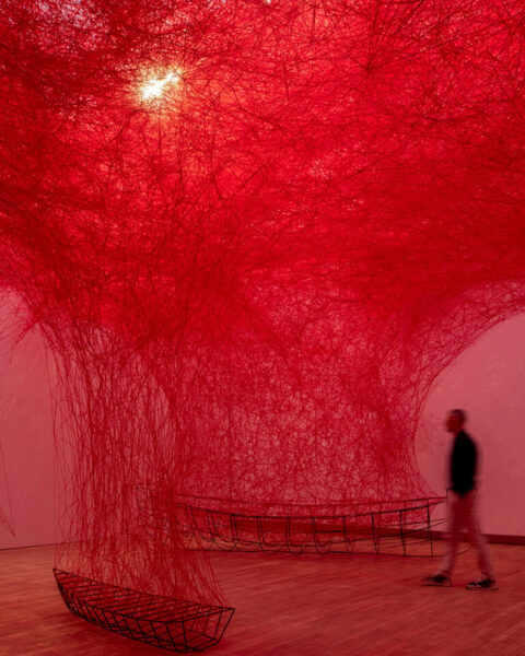 A red room full of red tangling string.