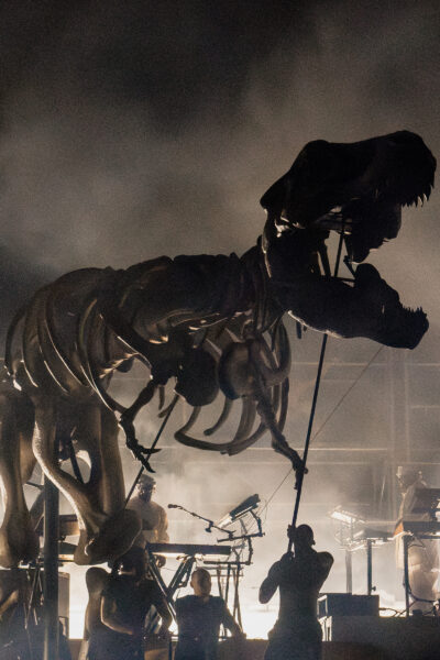 Large dinosaur T-Rex skeleton performing on a big music stage