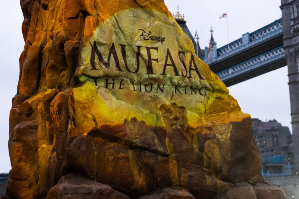 Rock formation in front of tower bride. Onto the rock there is a projection of the Disney Mufasa logo.