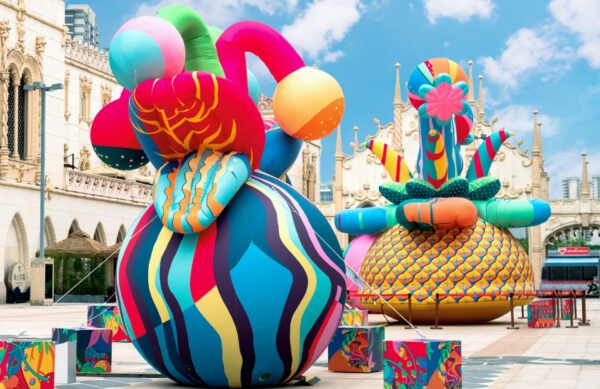 Colourful patterned inflatable sculptures in the middle of a city square.