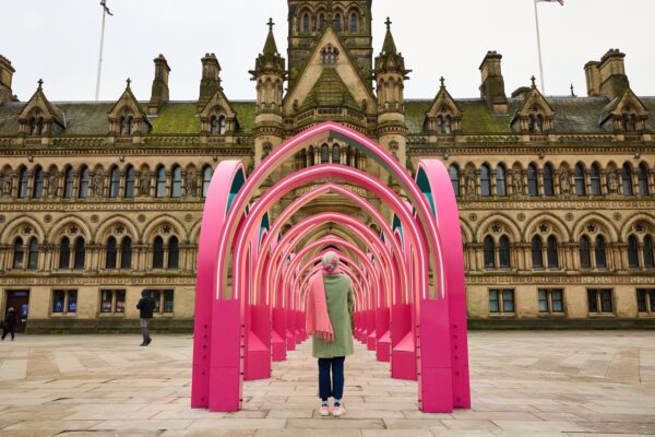Bright pink pavilion installation in the middle of bradford city centre square.