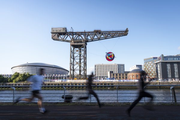 The Glasgow Rose suspended from the Finnieston Crane at sunset, overlooking the OVO Hydro in Glasgow.