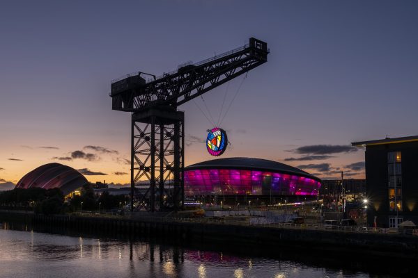 The Glasgow Rose suspended from the Finnieston Crane at sunset, overlooking the OVO Hydro in Glasgow.